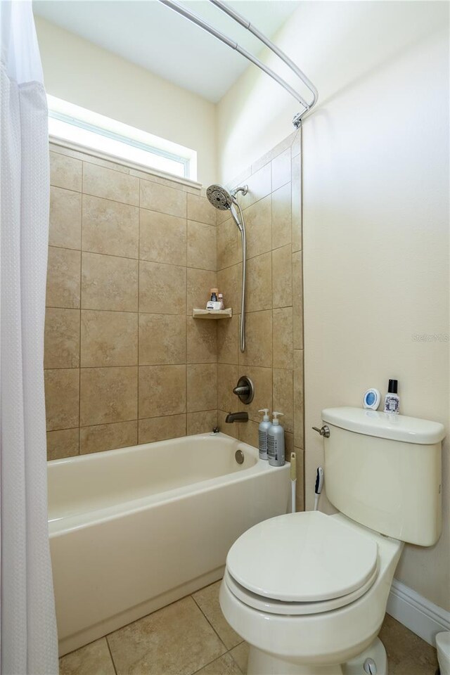4015 SE 22nd St, Ocala, FL 34471 - full bathroom with shower / bath combination with curtain, toilet, and tile patterned flooring