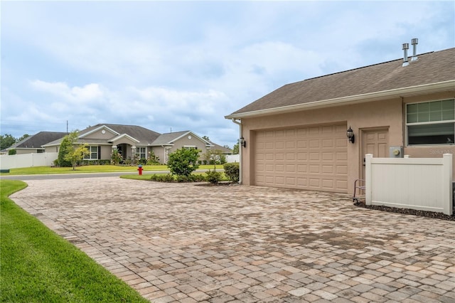 4015 SE 22nd St, Ocala, FL 34471 - garage featuring decorative driveway and a residential view