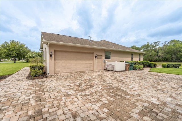 4015 SE 22nd St, Ocala, FL 34471 - view of home's exterior featuring stucco siding, an attached garage, and decorative driveway