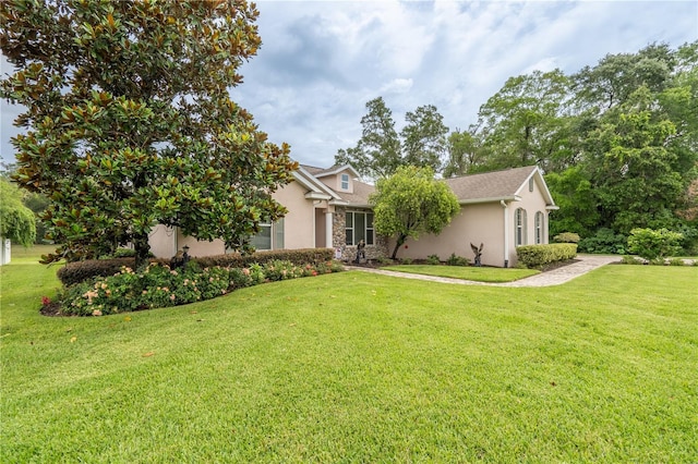 4015 SE 22nd St, Ocala, FL 34471 - view of property hidden behind natural elements featuring stucco siding, stone siding, and a front lawn