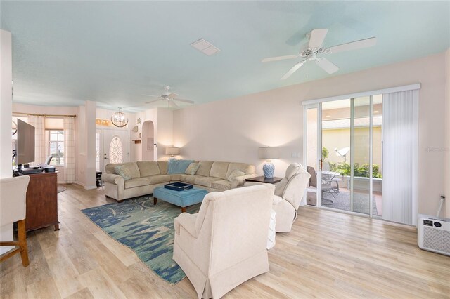 8303 SW 82nd Cir, Ocala, FL 34481 - living room with ceiling fan, arched walkways, wood finished floors, and an AC wall unit