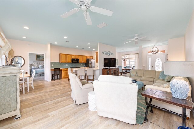 8303 SW 82nd Cir, Ocala, FL 34481 - living room featuring ceiling fan, light wood-style floors, a chandelier, and recessed lighting