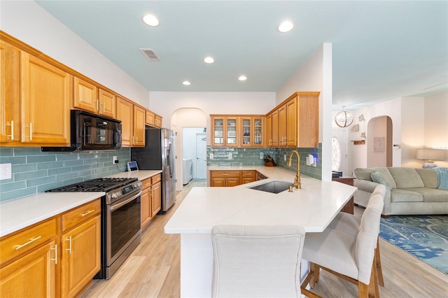 8303 SW 82nd Cir, Ocala, FL 34481 - kitchen with arched walkways, stainless steel appliances, open floor plan, a sink, and recessed lighting