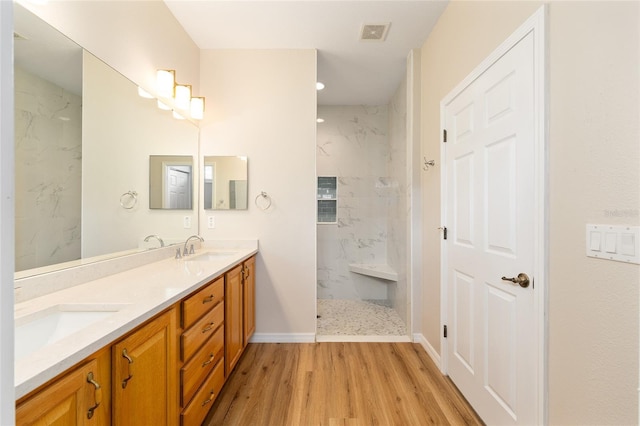 8303 SW 82nd Cir, Ocala, FL 34481 - full bath with wood finished floors, double vanity, a marble finish shower, baseboards, and recessed lighting