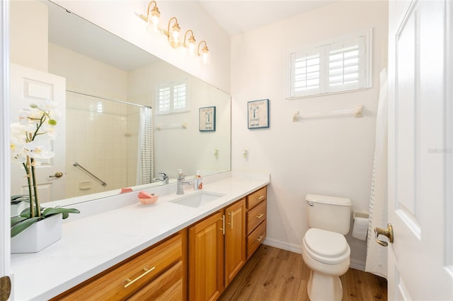 8303 SW 82nd Cir, Ocala, FL 34481 - bathroom featuring double vanity, plenty of natural light, wood finished floors, and toilet