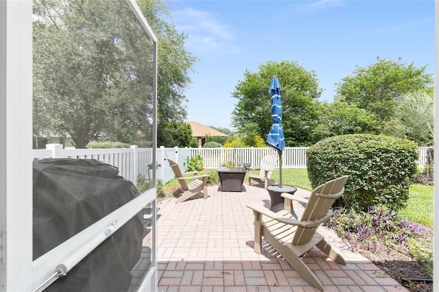 8303 SW 82nd Cir, Ocala, FL 34481 - fenced backyard with an outdoor fire pit, a patio area, and a grill