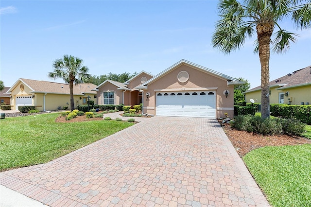 8303 SW 82nd Cir, Ocala, FL 34481 - ranch-style home featuring decorative driveway, stucco siding, an attached garage, and a front yard