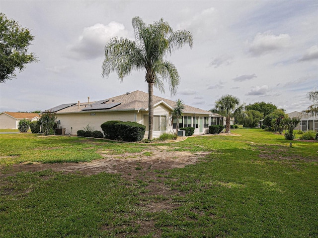 13863 SE 85th Cir, Summerfield, FL 34491 - view of property exterior with solar panels, a yard, and central AC