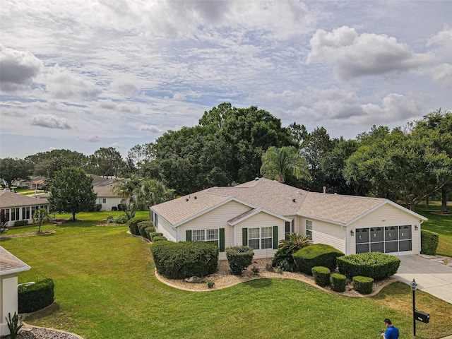 13863 SE 85th Cir, Summerfield, FL 34491 - view of front facade featuring concrete driveway, a front yard, an attached garage, and view of wooded area