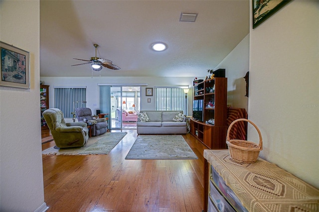 13863 SE 85th Cir, Summerfield, FL 34491 - living area featuring hardwood / wood-style flooring, a ceiling fan, and vaulted ceiling