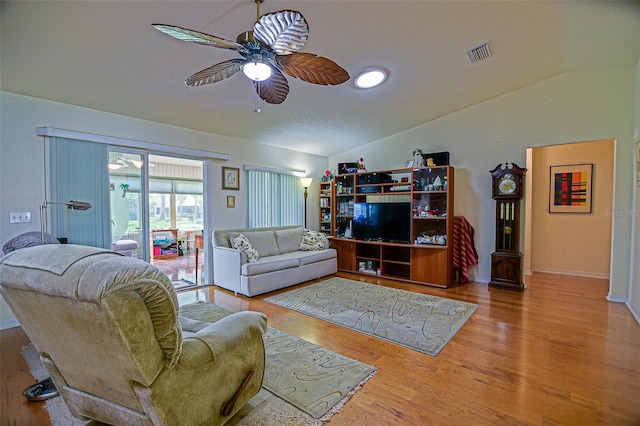 13863 SE 85th Cir, Summerfield, FL 34491 - living room featuring vaulted ceiling, a ceiling fan, wood finished floors, and baseboards