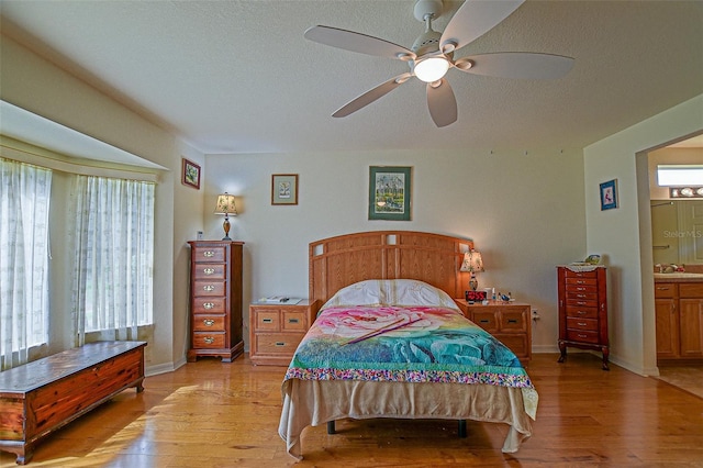 13863 SE 85th Cir, Summerfield, FL 34491 - bedroom with light wood-style flooring, baseboards, a sink, ceiling fan, and a textured ceiling
