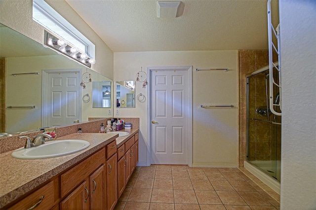 13863 SE 85th Cir, Summerfield, FL 34491 - bathroom with double vanity, a stall shower, a textured ceiling, and tile patterned floors