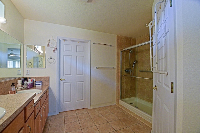 13863 SE 85th Cir, Summerfield, FL 34491 - full bath with vanity, a shower stall, tile patterned flooring, a ceiling fan, and a textured ceiling