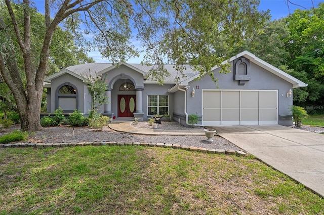 11 Calendula Ct E, Homosassa, FL 34446 - view of front of home with stucco siding, driveway, an attached garage, and roof with shingles