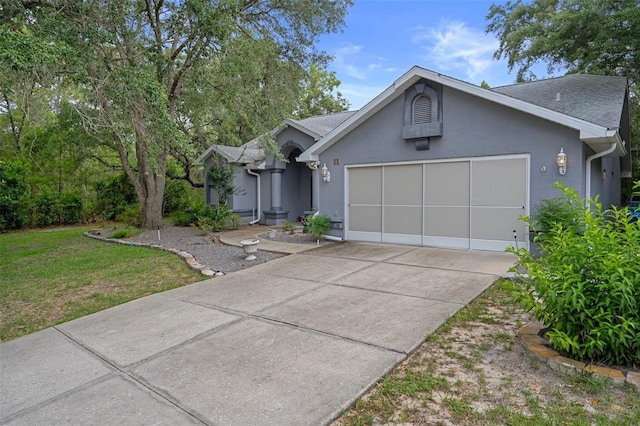 11 Calendula Ct E, Homosassa, FL 34446 - ranch-style home featuring a garage, concrete driveway, roof with shingles, stucco siding, and a front lawn