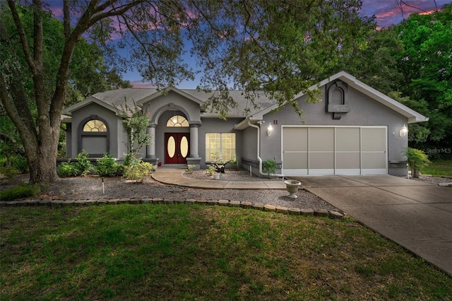 11 Calendula Ct E, Homosassa, FL 34446 - view of front of house with stucco siding, driveway, and an attached garage