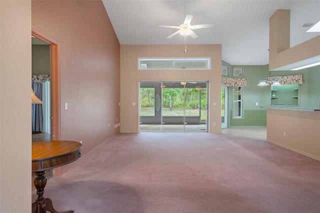 11 Calendula Ct E, Homosassa, FL 34446 - unfurnished living room with carpet, baseboards, a ceiling fan, and a high ceiling