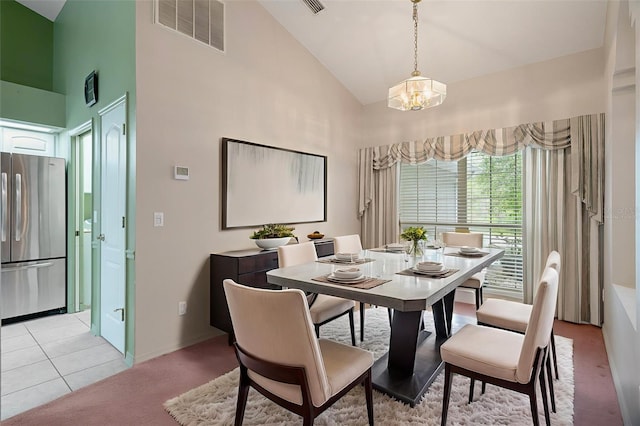 11 Calendula Ct E, Homosassa, FL 34446 - dining area with high vaulted ceiling, a chandelier, baseboards, light carpet, and light tile patterned flooring