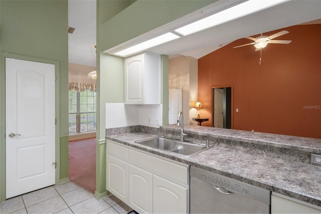 11 Calendula Ct E, Homosassa, FL 34446 - kitchen with dishwasher, a sink, vaulted ceiling, light tile patterned floors, and white cabinetry