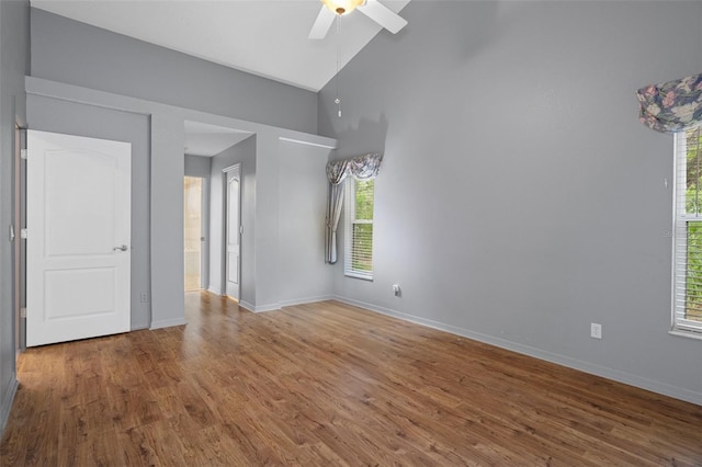 11 Calendula Ct E, Homosassa, FL 34446 - unfurnished room with a ceiling fan, wood finished floors, baseboards, and high vaulted ceiling