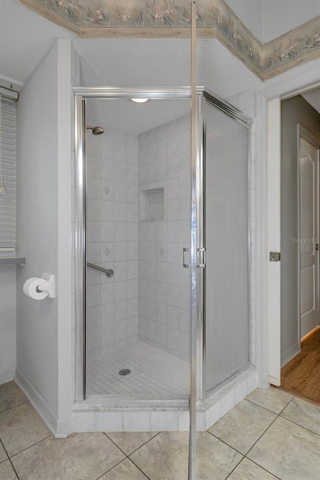 11 Calendula Ct E, Homosassa, FL 34446 - bathroom with tile patterned flooring, a stall shower, and baseboards