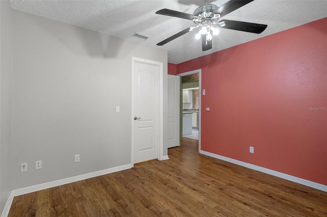 11 Calendula Ct E, Homosassa, FL 34446 - unfurnished bedroom with wood finished floors, baseboards, a textured ceiling, and ceiling fan