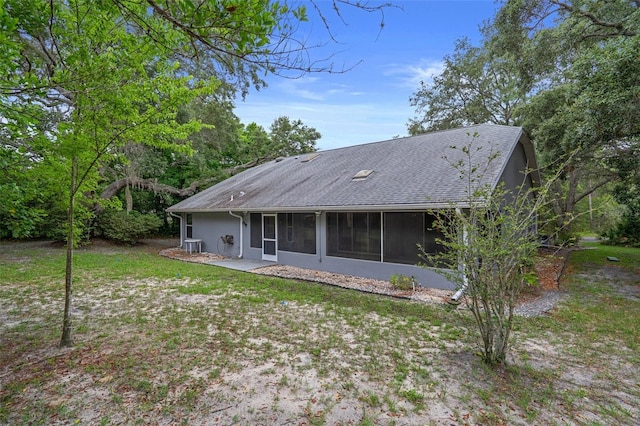 11 Calendula Ct E, Homosassa, FL 34446 - rear view of house featuring a sunroom, roof with shingles, a yard, and stucco siding