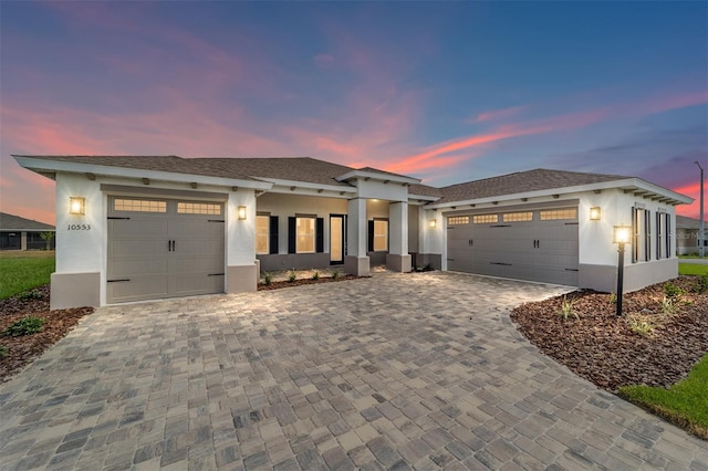 10553 SW 98th Pl, Ocala, FL 34481 - view of front of house with an attached garage, stucco siding, and decorative driveway