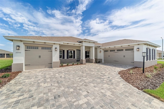 10553 SW 98th Pl, Ocala, FL 34481 - view of front of home featuring stucco siding, an attached garage, and decorative driveway