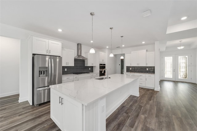 10553 SW 98th Pl, Ocala, FL 34481 - kitchen with stainless steel refrigerator with ice dispenser, wall chimney range hood, a sink, decorative backsplash, and a spacious island