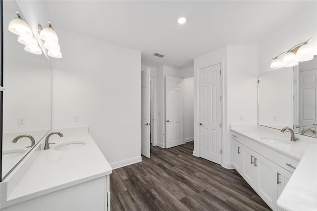 10553 SW 98th Pl, Ocala, FL 34481 - full bath with two vanities, wood finished floors, and baseboards