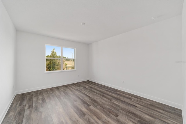 10553 SW 98th Pl, Ocala, FL 34481 - empty room with dark wood-style flooring and baseboards