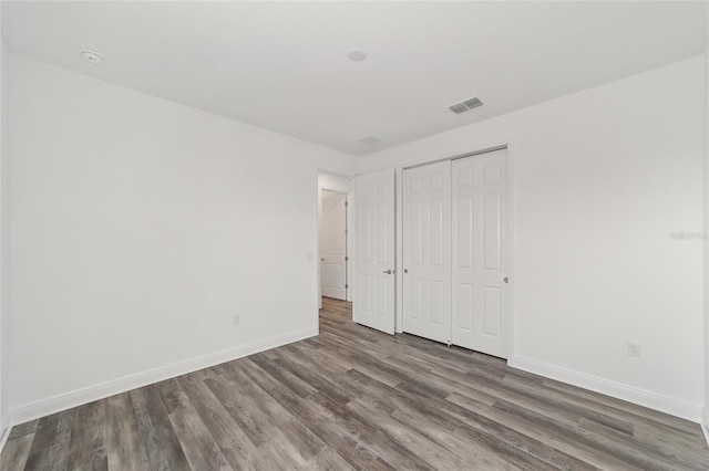 10553 SW 98th Pl, Ocala, FL 34481 - unfurnished bedroom featuring wood finished floors, baseboards, and a closet