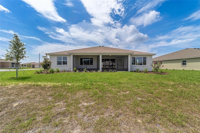 10553 SW 98th Pl, Ocala, FL 34481 - back of house featuring stucco siding, a yard, and a sunroom