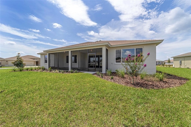 10553 SW 98th Pl, Ocala, FL 34481 - back of house with a sunroom, a yard, and stucco siding