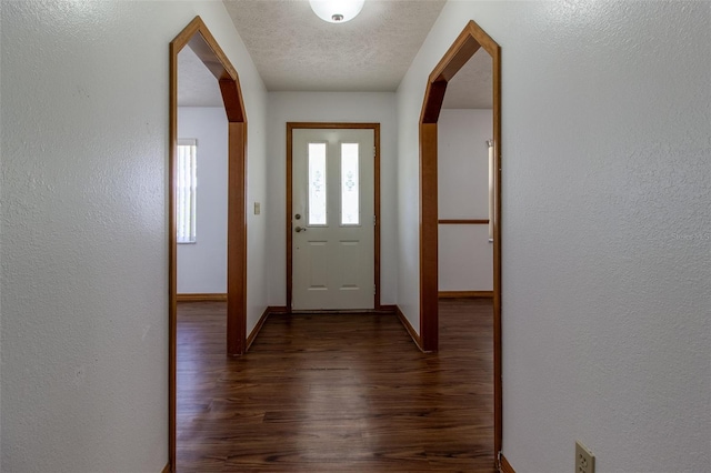 3295 SE 56th Ave, Ocala, FL 34480 - entrance foyer featuring wood finished floors, baseboards, a textured wall, and arched walkways