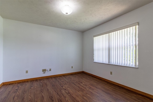 3295 SE 56th Ave, Ocala, FL 34480 - empty room with wood finished floors, baseboards, and a textured ceiling