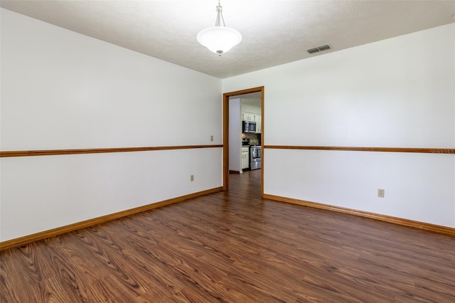 3295 SE 56th Ave, Ocala, FL 34480 - empty room featuring wood finished floors and baseboards