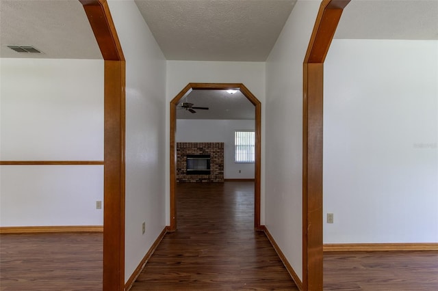 3295 SE 56th Ave, Ocala, FL 34480 - hall featuring wood finished floors, a textured ceiling, and baseboards