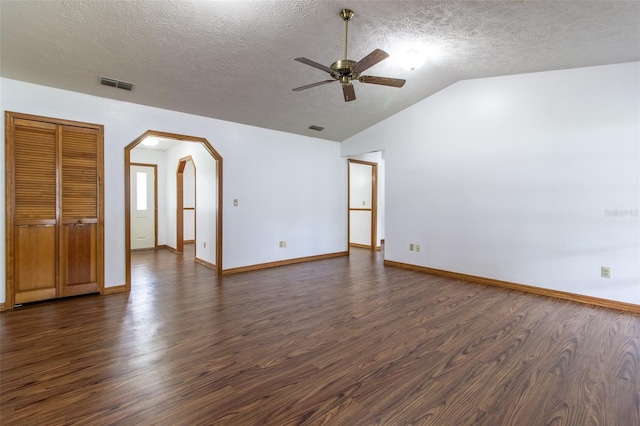 3295 SE 56th Ave, Ocala, FL 34480 - empty room featuring ceiling fan, dark wood-type flooring, lofted ceiling, a textured ceiling, and arched walkways