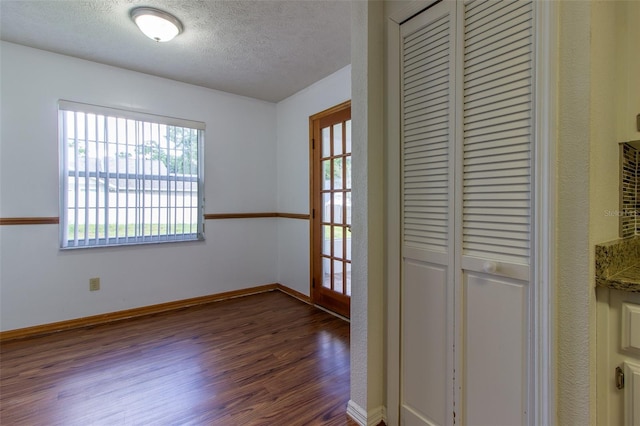 3295 SE 56th Ave, Ocala, FL 34480 - interior space with dark wood-style flooring, a textured ceiling, and baseboards