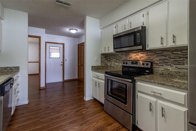 3295 SE 56th Ave, Ocala, FL 34480 - kitchen with appliances with stainless steel finishes, dark wood-style floors, backsplash, baseboards, and a textured ceiling