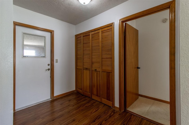 3295 SE 56th Ave, Ocala, FL 34480 - hallway featuring dark wood-type flooring, baseboards, and a textured ceiling