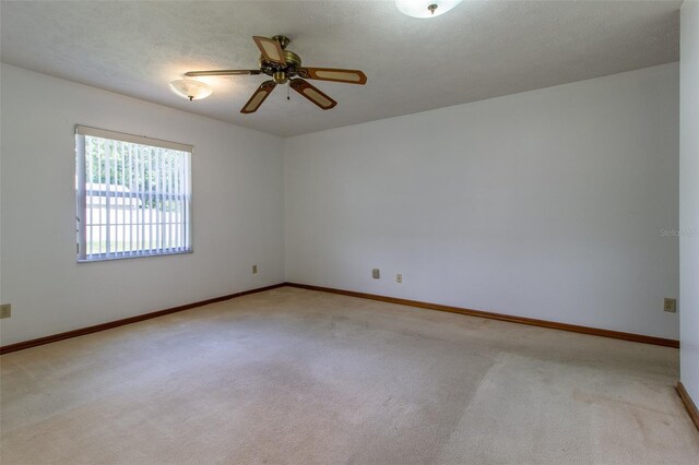 3295 SE 56th Ave, Ocala, FL 34480 - empty room with carpet floors, ceiling fan, and baseboards