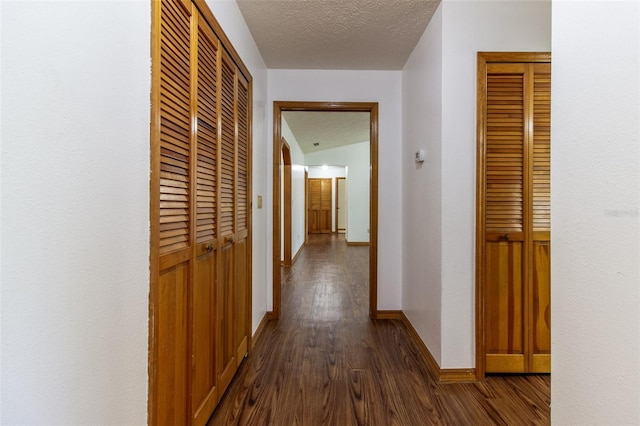 3295 SE 56th Ave, Ocala, FL 34480 - hall with dark wood-type flooring, baseboards, and a textured ceiling