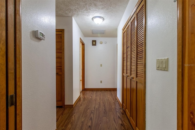 3295 SE 56th Ave, Ocala, FL 34480 - corridor featuring dark wood-type flooring, a textured ceiling, and baseboards