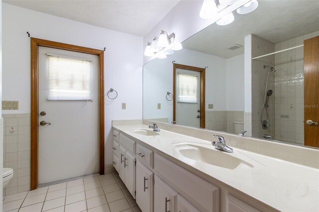 3295 SE 56th Ave, Ocala, FL 34480 - full bathroom with toilet, double vanity, tiled shower, and a chandelier