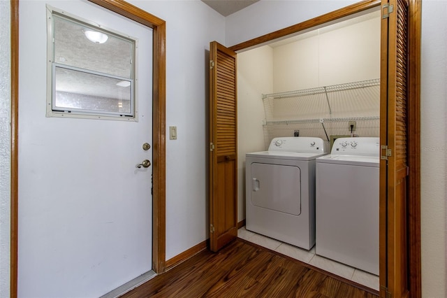 3295 SE 56th Ave, Ocala, FL 34480 - laundry room featuring washing machine and clothes dryer, dark wood-type flooring, and baseboards
