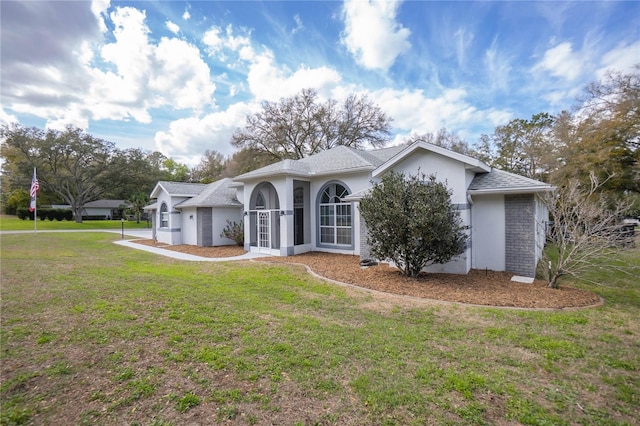 8015 N Tower Way, Citrus Springs, FL 34434 - ranch-style house featuring stucco siding, a front yard, and roof with shingles